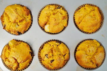 Tray of homemade vegan pumpkin muffins with pears and dried cherries