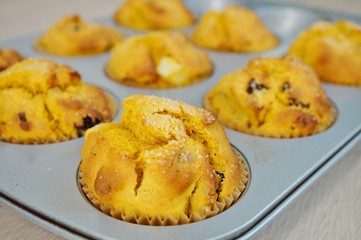 Tray of homemade vegan pumpkin muffins with pears and dried cherries