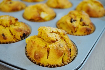Tray of homemade vegan pumpkin muffins with pears and dried cherries