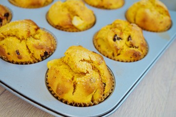 Tray of homemade vegan pumpkin muffins with pears and dried cherries