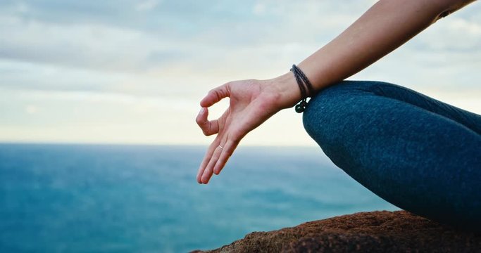 Close up of hand in yoga pose, young woman practicing yoga