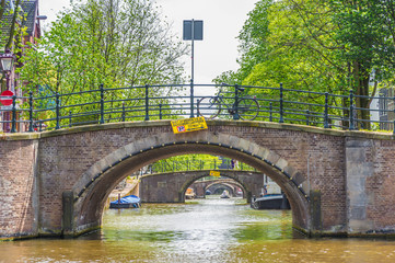 Fototapeta premium Bridge across Amsterdam channel, Netherlands.