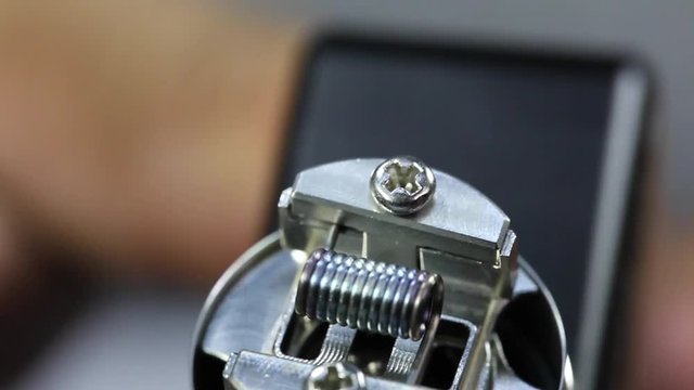 burning a new kanthal micro coil on the atomizer’s deck base of electronic cigarette for vaping, close up scene, high definition, Full HD, 1920x1080