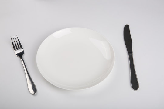 Plate knife and fork on the white