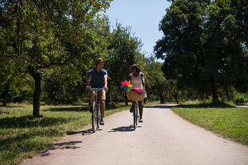 Obraz premium Young multiethnic couple having a bike ride in nature