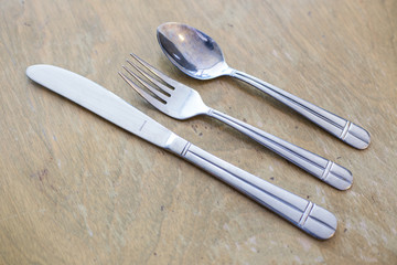 knife fork and spoon on a wooden table