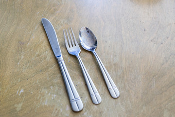 knife fork and spoon on a wooden table