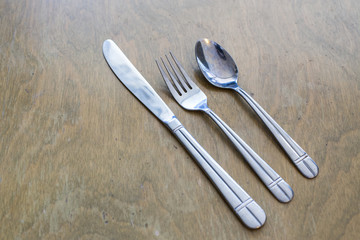 knife fork and spoon on a wooden table