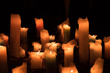 The flame of the candle and black scenery