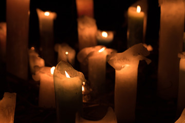 The flame of the candle and black scenery