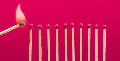 Burning matchsticks setting fire to its neighbors