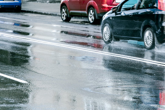 Cars Driving On Wet Asphalt Road After Heavy Rain