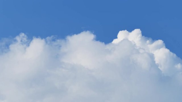 Cloudscape time-lapse 4k nature video: rolling cumulus clouds moving on blue sky sunny day 