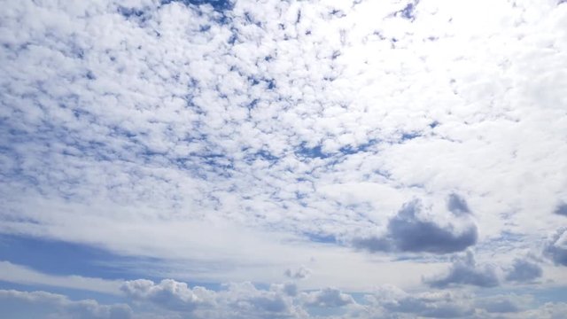 Cloudscape time-lapse 4k nature video: rolling cumulus clouds moving on blue sky sunny day 