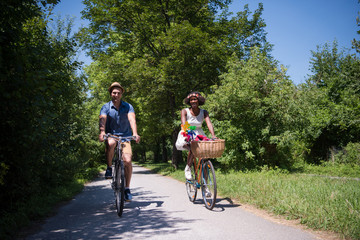 Naklejka premium Young multiethnic couple having a bike ride in nature