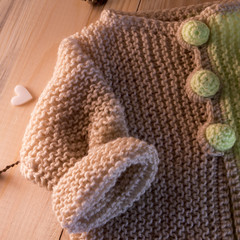 knitted sweater on the wooden background