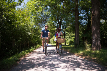 Fototapeta premium Young multiethnic couple having a bike ride in nature