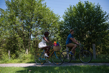 Fototapeta premium Young multiethnic couple having a bike ride in nature