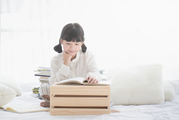 Beautiful Asian girl reading a book