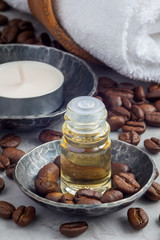 Obraz na płótnie Canvas Coffee essential oil in a glass bottle. Vertical, close-up