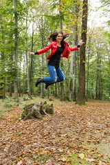 girl in the forest jumping