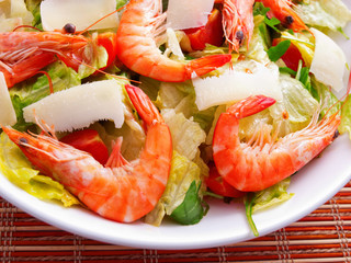 Green salad with shrimps and parmesan cheese. Horizontal shot