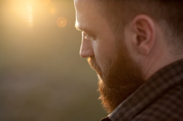 close-up of a young bearded man with back side view