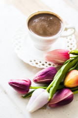Cup of coffee with tulip flower