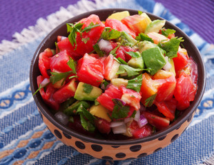 Tomatoes and avocado salad with red onion. Horizontal shot