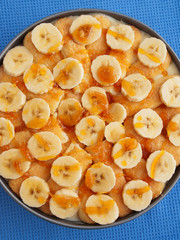 Homemade cake with bananas and caramel in a bowl. Shot from abov