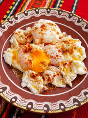 Poached eggs with red pepper. Vertical shot.