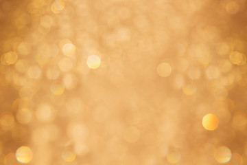 Christmas bokeh background. Golden background with blurred lights.
