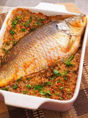 Baked carp in casserole with rice. Vertical shot