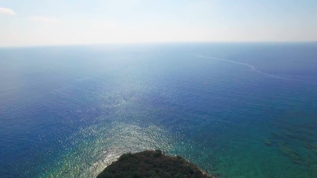 Aerial View of the Tropical Coast with Dense Forest and the Bay with the Blue Water. Sunny Day, Shot in 4K UHD