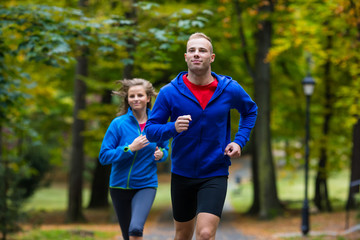 Woman and man running in park