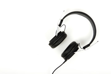 Black headphones against a light coloured background