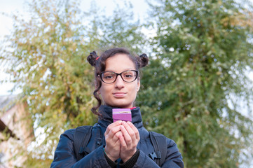 Girl brunette holding a beautiful box in hands  