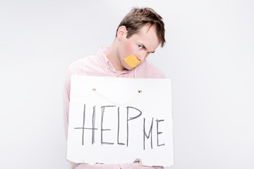 Tied man with taped mouth as a hostage in studio