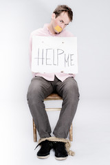 Tied man with taped mouth as a hostage in studio