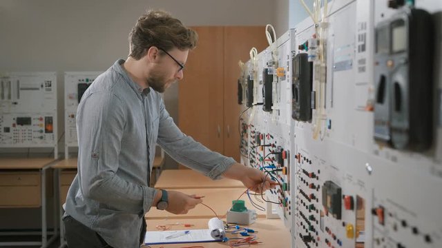 A student in the laboratory learn lecture and connect colored cables to the device