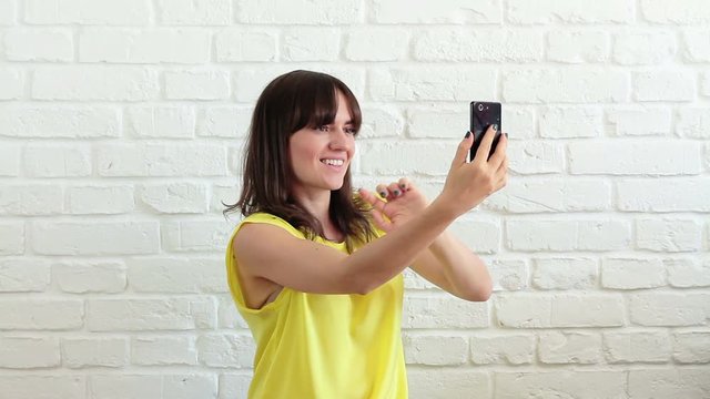 Young happy woman taking selfie on mobile phone

