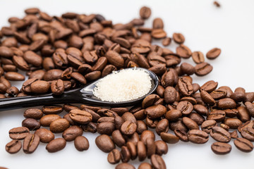 Coffee beans, brown sugar and small teaspoons