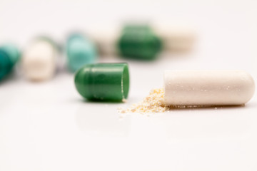 Composition with colorful pills and broken capsules
