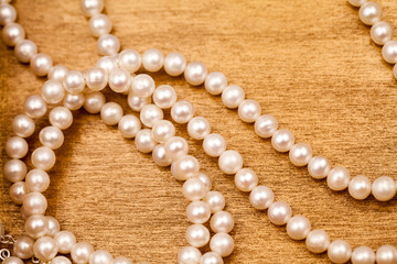 Pearls on a wooden surface