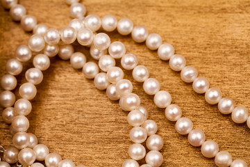 Pearls on a wooden surface