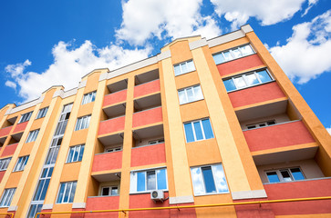 New modern apartment building against the blue sky background