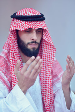 Younger Muslim Arabic man praying