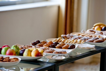 table covered with cakes and fruits