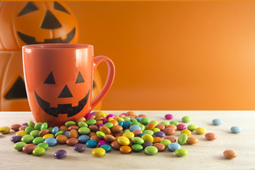 cup and candy on orange bucket background