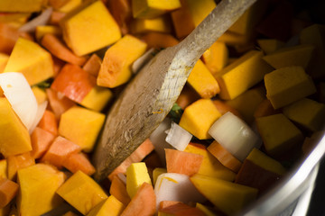 Diced vegetables for a pumpkin soup in the pot  - close-up